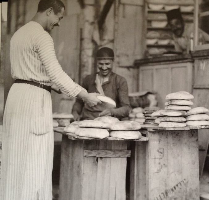 Bread seller on Wad St. in the Old City of Jerusalem, 1939.